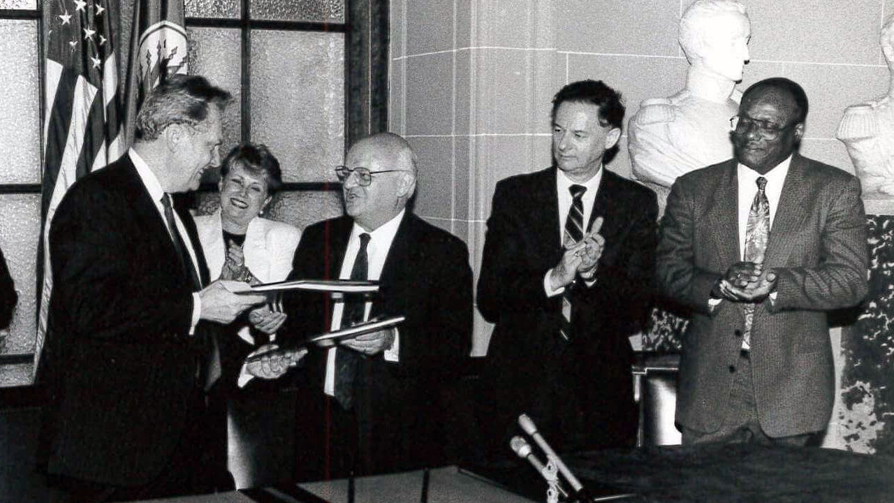 Ambassador Luigi R. Einaudi and Joao Clemente Baena Soares, Secretary General, OAS during the signing of the Headquarters Agreement, 1992.