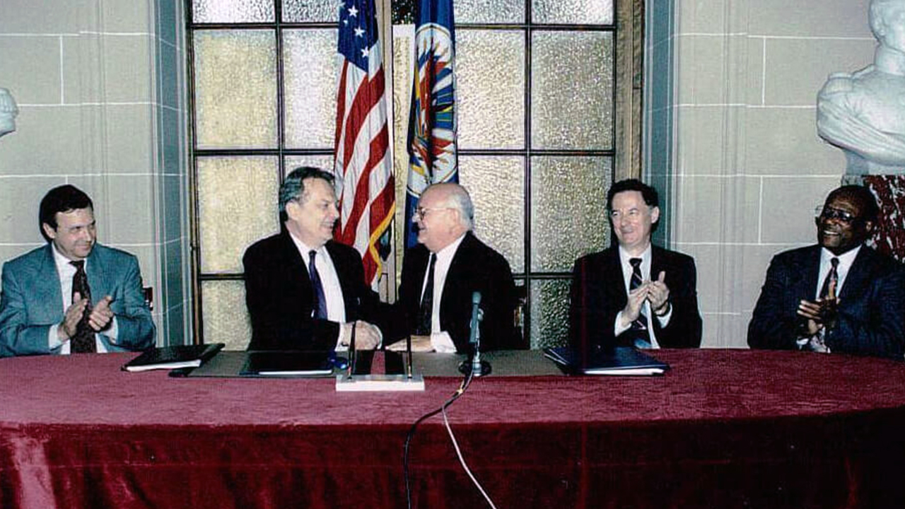 Ambassador Luigi R. Einaudi and Joao Clemente Baena Soares, Secretary General, OAS during the signing of the Headquarters Agreement, 1992.